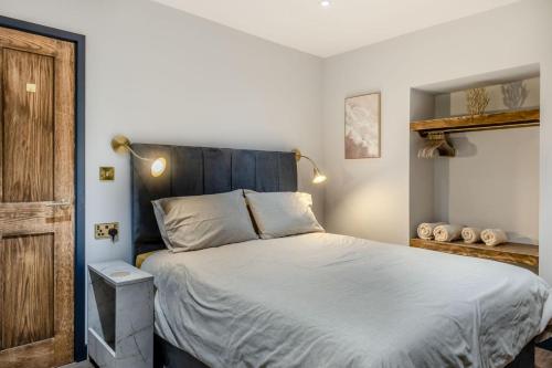a bedroom with a large bed with a blue headboard at 2 Bed in Tenby oc-b41402 in Tenby