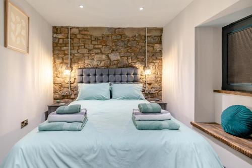 a bedroom with a large bed with pillows on it at 2 Bed in Tenby oc-b41400 in Tenby