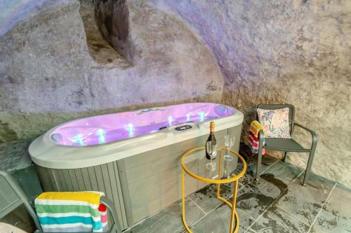 a bathroom with a bath tub and a chair at 2 Bed in Tenby oc-b41399 in Tenby