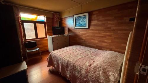 a bedroom with a bed and a television in it at VillaHouse - Huaraz in Huaraz