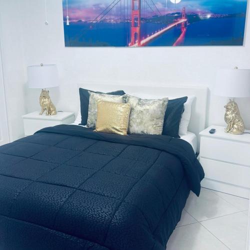 a bed with a blue comforter in a bedroom at Private Miami Suite in Tamiami Airport