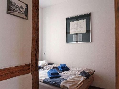 a room with a bed with blue towels on it at Courtyard Idyll Apartment in Rostock