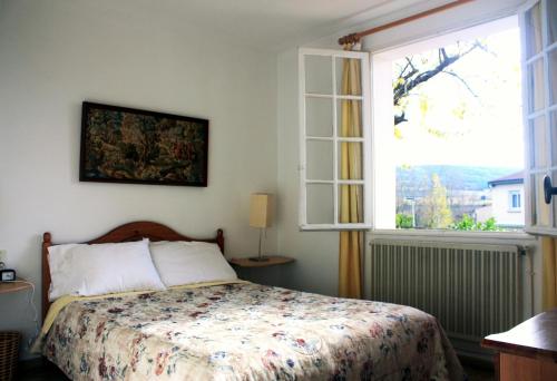 1 dormitorio con cama y ventana grande en Les Lauriers, en Limoux
