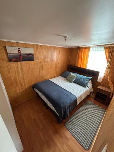 a bedroom with a bed in the middle of a boat at Ruta Pata Austral in Puerto Varas