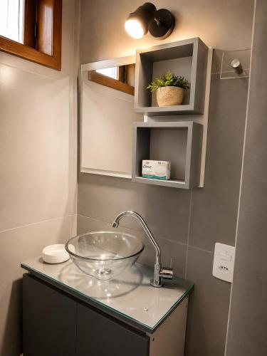 a bathroom with a glass bowl sink on a counter at Refúgio das Rosas in Pedro do Rio