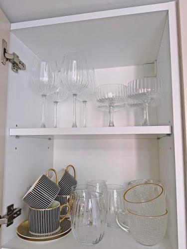 a bunch of wine glasses sitting on a shelf at The Emerald Loft I Terrace I Free Parking in Kaunas