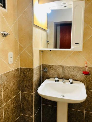 a bathroom with a sink and a mirror at Hotel el Progreso in Olta
