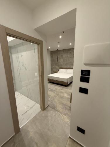 a bedroom with a bed and a sliding glass door at Hotel Corona in Termoli