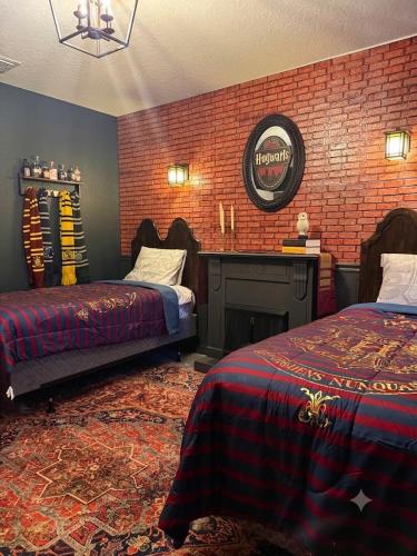 a bedroom with two beds and a brick wall at Disney 8BR South Pool Theater Arcade Harry Potter Room in Davenport