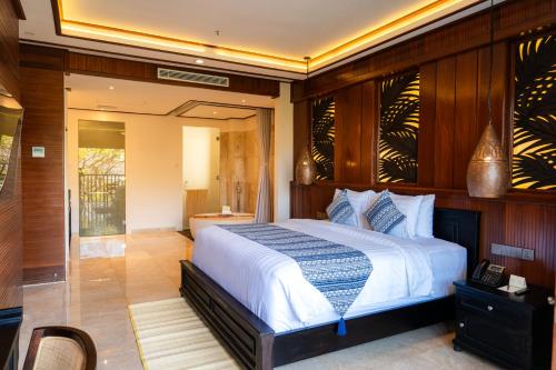 a bedroom with a large bed in a room at Bali Tropic Resort & Spa - CHSE Certified in Nusa Dua