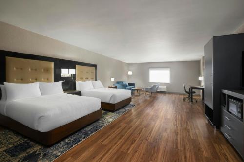 a hotel room with two beds and a fireplace at Four Points by Sheraton Rock Springs in Rock Springs