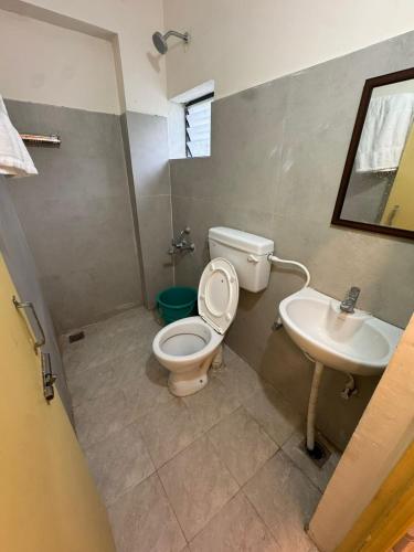 a bathroom with a toilet and a sink at Laya Crest in Chennai