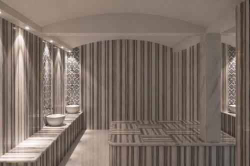 a bathroom with two sinks and a striped wall at TRYP by Wyndham Didim in Didim