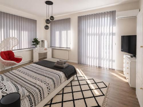 a bedroom with a bed and a tv and windows at WlodawaSpot in Włodawa