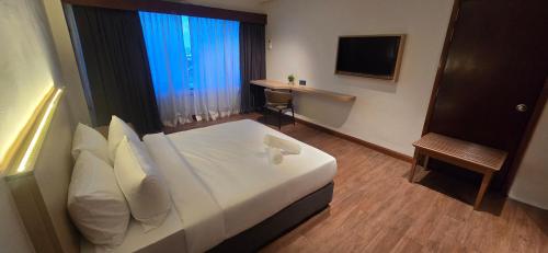 ein Hotelzimmer mit Bett und Fernseher in der Unterkunft Kingston Hotel 28 - Gocos Hotel Klang in Klang