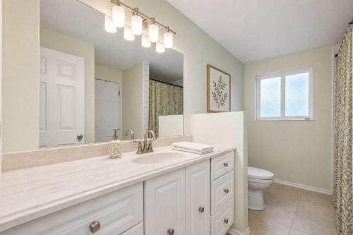 a white bathroom with a sink and a toilet at First Tracks Cabin in Eden