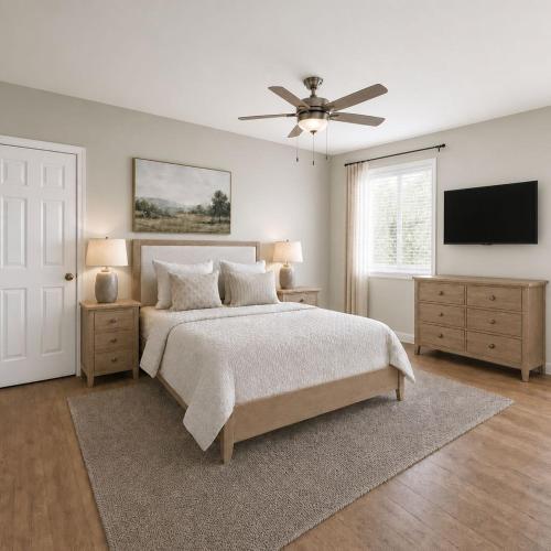 a bedroom with a bed and a flat screen tv at First Tracks Cabin in Eden