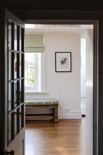 a room with a bench in front of a window at Raffah House in Oatlands