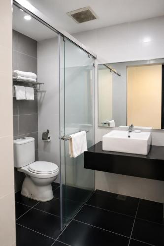 a bathroom with a toilet and a sink at Manhattan Hotel Ipoh in Ipoh