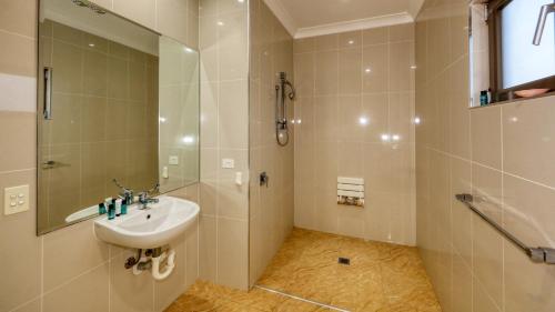 a bathroom with a sink and a shower at Western Downs Motor Inn in Miles