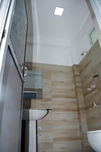 a bathroom with a toilet and a sink at Lasya Residence in Trincomalee