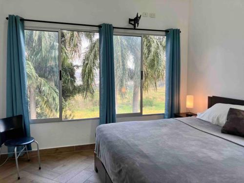 a bedroom with a bed and a large window at Casa Roraima in San Antonio