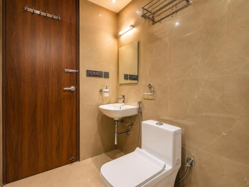a bathroom with a toilet and a sink at Hotel Starlink By The Nine Hotel in Jaipur