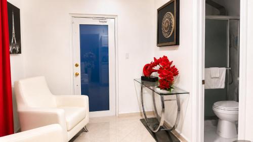 a bathroom with a white toilet and a white chair at Private Miami Suite in Tamiami Airport
