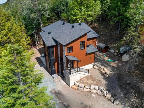 an overhead view of a house in the woods at Alta Vita Ste-Adèle Modern, Forest, Spa and Sauna in Sainte-Adèle