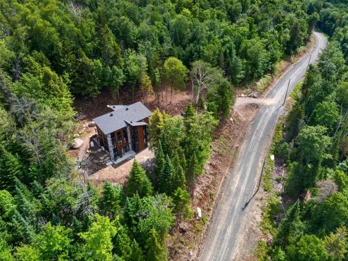 an aerial view of a house in the middle of a forest at Alta Vita Ste-Adèle Modern, Forest, Spa and Sauna in Sainte-Adèle