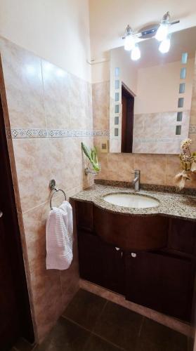 a bathroom with a sink and a mirror at Retiro de Las Cañas in Fray Bentos