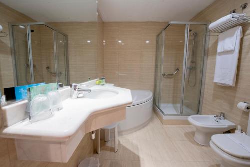 a bathroom with a sink and a shower and a toilet at Silken Sant Gervasi in Barcelona