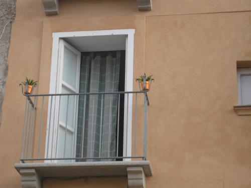 a balcony with two potted plants on it at Lo Splendore del Borgo in Tropea