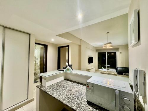 a kitchen with a sink and a counter top at 9 de Julio Park Suites in San Miguel de Tucumán