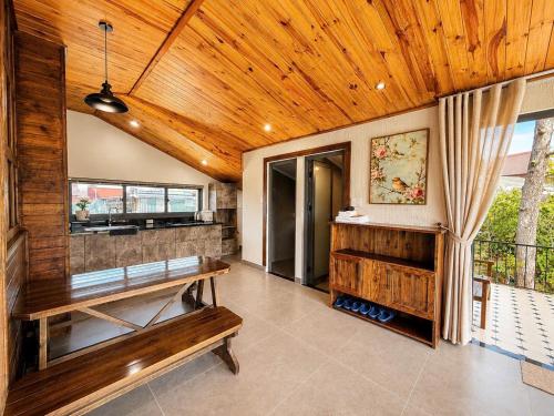 a room with a wooden ceiling and a bench at An Valley Villa Đà Lạt in Da Lat
