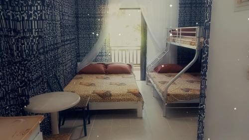a room with two bunk beds and a table at Old House On The Beach Asprovalta 1 in Asprovalta