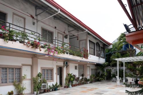 a building with flowers on the balconies and a courtyard at En Pensionne Comfort in Iloilo City