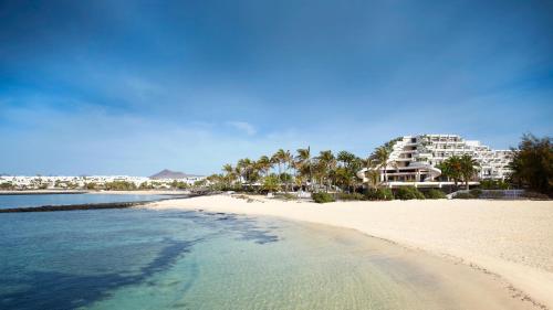 a view of a beach with a resort in the background at Paradisus Salinas Lanzarote - All Inclusive - Adults Only in Costa Teguise