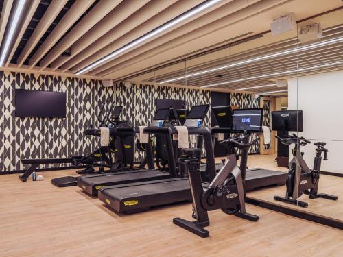a gym with treadmills and elliptical machines at ME by Meliá Lisbon in Lisbon