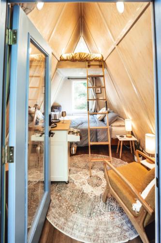 a bedroom with a bed and a desk in a room at Charming A-Frame Couples Retreat Cozy and Private in Rockbridge