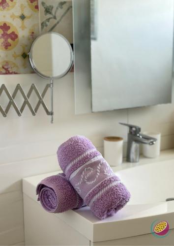a purple towel sitting on top of a bathroom sink at Studio Belle Place in Le Gosier