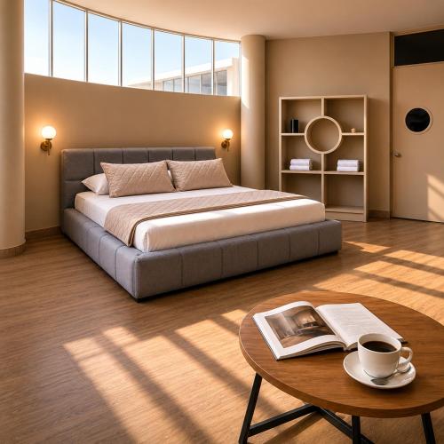 a bedroom with a bed and a table with a book at Altitud 620 Boutique Suites in Nazca