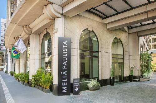 a building with a sign on the side of it at Meliá Paulista in São Paulo