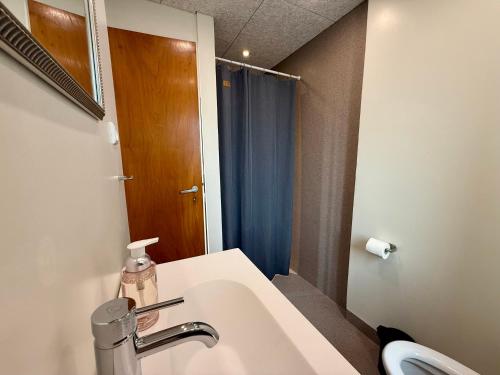 a bathroom with a sink and a mirror at Charming Townhouse In Thyborøn in Thyborøn