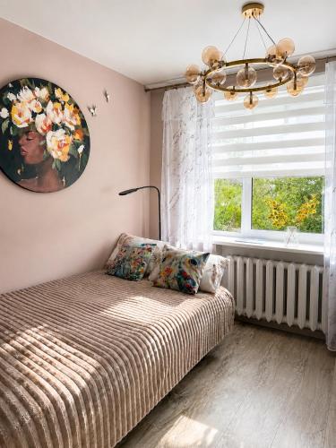 a bedroom with a bed and a large window at SMART flat - Ranna 49 in Sillamäe