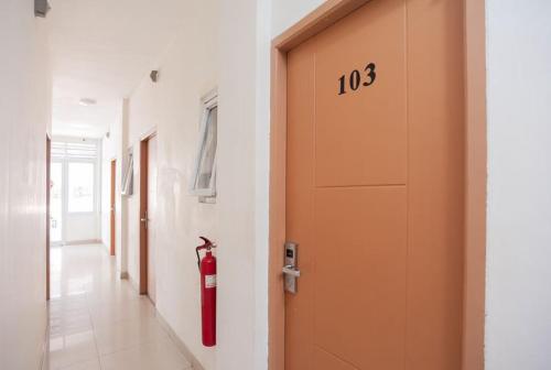 a fire hydrant is on the wall of a hallway at Ava Guesthouse Lampung in Tanjungkarang