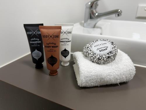 a bathroom counter with some products on a towel at Dooley's Tavern & Motel Springsure in Springsure