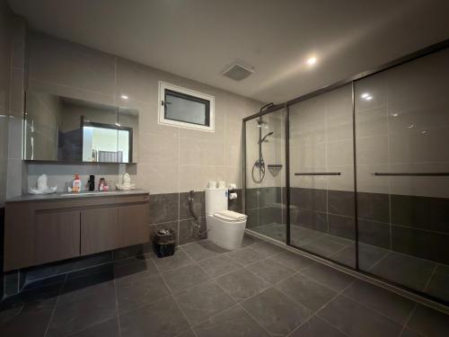 a bathroom with a shower and a toilet and a sink at Plaza Hotel in Dili