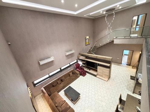 an overhead view of a living room with a staircase at Manav Farmhouse in Olpād