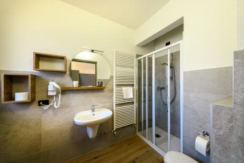 a bathroom with a sink and a shower at Hotel Club Funivia in Aprica